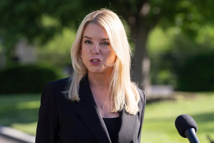 Pam Bondi speaks to reporters outdoors