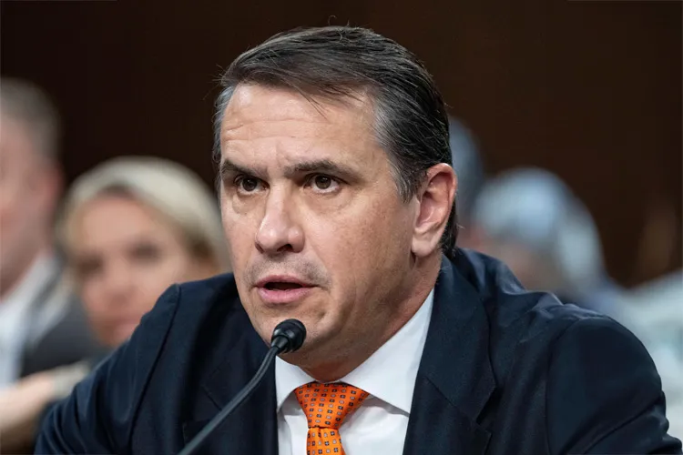 Todd Blanche speaks into a microphone while testifying at a Senate hearing