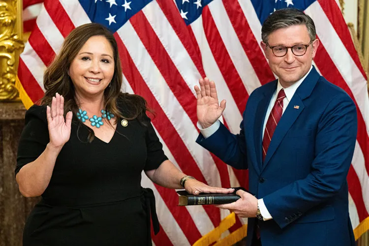 House Speaker Mike Johnson administers the oath of office to Arizona Democrat Adelita Grijalva in front of American flags
